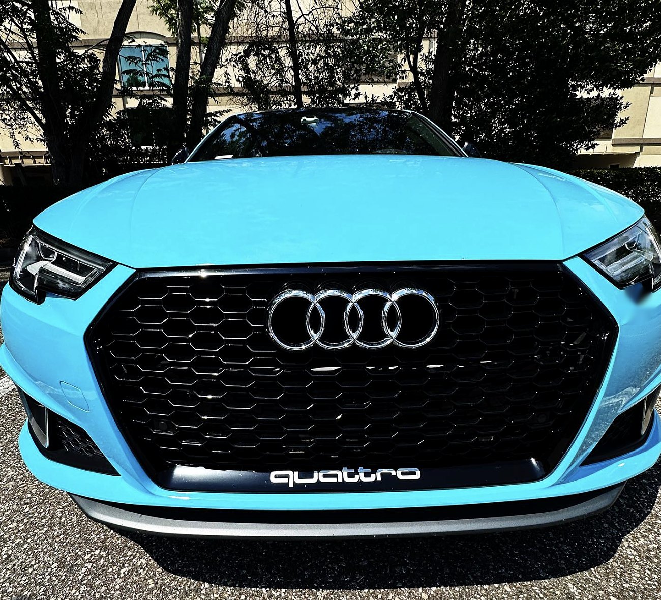 Audi A4 wrapped in gloss baby blue vinyl by GCAT, front view